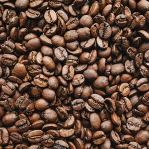 A high-resolution close-up photo of rich, aromatic roasted coffee beans.